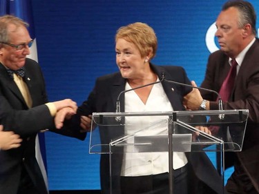 On the night she was elected Quebec's first woman premier in 2012, Parti Québécois leader Pauline Marois is whisked off stage after a gunman fired a shot outside the PQ's election headquarters.
