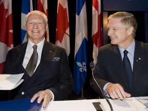 Power Corporation Chairman and co-CEO Paul Desmarais, right, and André Desmarais at the company's annual general meeting in 2012.