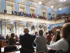 Indigenous leaders join hands while members of the National Assembly applaud after Quebec Premier Francois Legault apologized to First Nations and Inuit leaders during a declaration at the legislature in Quebec City Wednesday, October 2, 2019. Legault was speaking in the wake of the Viens Commission report, which concluded First Nations and Inuit people face serious and systemic discrimination by service providers, including police forces.