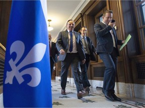 Quebec Premier François Legault, centre, walks to question period, Saturday December 7, 2019 in Quebec City.