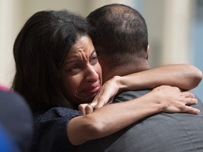 Quebec Liberal MNA Dominique Anglade gets a hug from Quebec Health Minister Lionel Carmant after she tabled a motion marking the 10th anniversary of the earthquake in Haiti, Thursday, December 5, 2019 at the legislature in Quebec City. Anglade lost her father and mother in the 2010 earthquake.