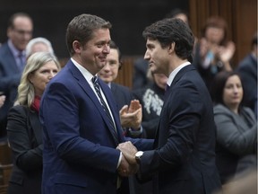 Prime Minister Justin Trudeau shakes hands with Leader of the Opposition Andrew Scheer after he announced he will step down as leader of the Conservatives, Thursday December 12, 2019 in the House of Commons in Ottawa.
