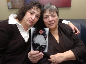 Sister Clara and mother Sara hold a photograph of Anee Khudaverdian in 2008.