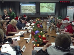 The NORAD crew hard at work in 2014 tracking Santa as he starts his journey.