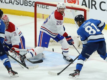 Winnipeg Jets forward Kyle Connor (right) puts a loose puck past Montreal Canadiens defenceman Jeff Petry with goaltender Carey Price out of position in Winnipeg on Mon., Dec. 23, 2019.