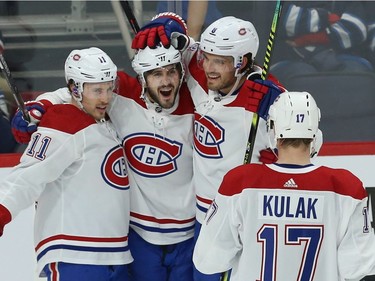 Montreal Canadiens centre Phillip Danault (second from left) celebrates his goal against the Winnipeg Jets in Winnipeg with Brendan Gallagher, Ben Chiarot and Brett Kulak (from left) on Mon., Dec. 23, 2019.