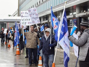 Unionized workers from Swissport picket outside Trudeau Airport after declaring a strike Tuesday December 31, 2019.