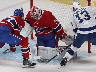 Tampa Bay Lightning's Cedric Paquette (13) gets in close on Montreal Canadiens goaltender Carey Price with Brett Kulak (17) coming in to help him, during third period NHL action in Montreal on Thursday Jan. 2, 2020.