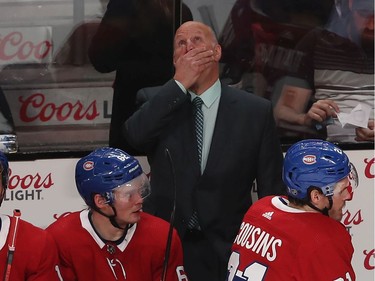 Montreal Canadiens coach Claude Julien rubs his face has he looks up at the scoreboard during third period NHL action in Montreal on Thursday Jan. 2, 2020.