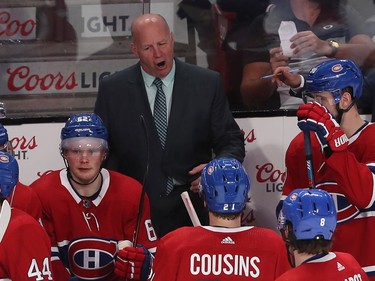 Montreal Canadiens coach Claude Julien speaks to his players during a break in the third period NHL action in Montreal on Thursday Jan. 2, 2020.