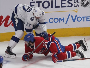 Tampa Bay Lightning's Alex Killorn (17) brings down Montreal Canadiens' Phillip Danault (24) during second period NHL action in Montreal on Thursday Jan. 2, 2020.