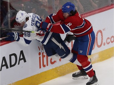 Montreal Canadiens' Ben Chiarot (8) brings Tampa Bay Lightning's Mikhail Sergachev (98) into the boards during third period NHL action in Montreal on Thursday Jan. 2, 2020.