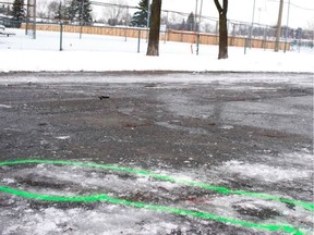 Police markings outline the bloodstains left behind by a stabbing on Jan. 1, 2020, in a parking lot adjacent to Parc Marc-Aurèle-Fortin in Laval.