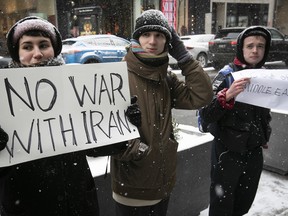 Protesters are seen outside the U.S. consulate in Montreal on Monday, Jan. 6, 2020.