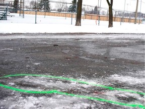 Police markings outline the bloodstains from the fatal stabbing of Ryad Benchouk on Jan. 1 in a parking lot adjacent to Parc Marc-Aurèle-Fortin in Laval.