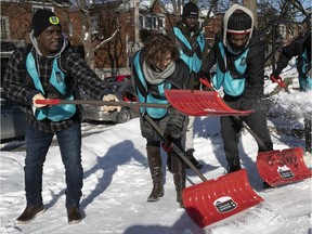 Côte-des-Neiges--Notre-Dame-de-Grâce borough mayor Sue Montgomery, second from left, gives pointers to new snow crew members Bayo Oshoteku, Toumany Dantiogo and Christopher Lewis.