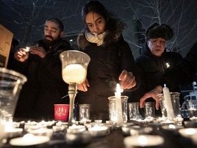 People light candles during a vigil outside Concordia University for the victims of the Ukraine International Airlines flight that crashed this week.