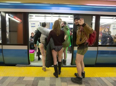 A participant of the annual No Pants Day waves as he boards the métro in Montreal on Sunday, Jan. 12, 2020.