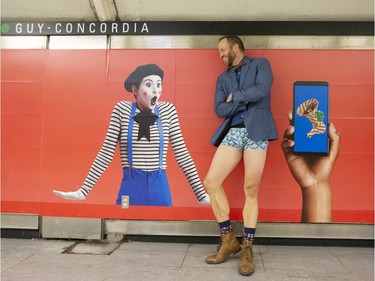 A participant and one of the organizers of the annual No Pants métro ride hams it up as he waits on the platform in Montreal on Sunday, Jan. 12, 2020.