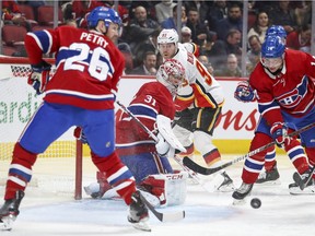 Montreal Canadiens Jeff Petry, Carey Price and Nick Suzuki and Calgary Flames Sam Bennett track the puck in the Habs end during second period of National Hockey League game in Montreal Monday January 13, 2020.