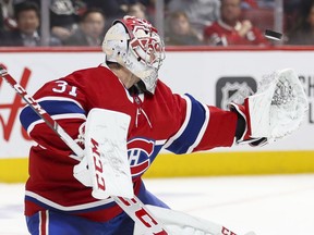 Montreal Canadiens' Carey Price makes a glove save during second period against the Calgary Flames in Montreal on Jan. 13, 2020.