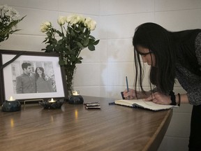 A student signs a book of condolences for Negar Borghei, who died in the Jan. 8, 2020 plane crash in Iran. The ceremony was held at Macdonald Campus on Thursday, Jan. 16, 2020.