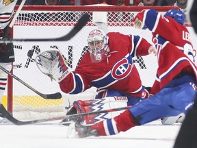 Montreal Canadiens goalie Charlie Lindgren reaches for shot that went for a goal by Chicago Blackhawks Alex DeBrincat during second period of National Hockey League game in Montreal Wednesday January 15, 2020.