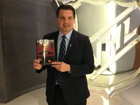 Ed Olczyk with his new book Beating the Odds in Hockey and in Life, which chronicles his time in the NHL and his battle with colon cancer. Credit: Triumph Books