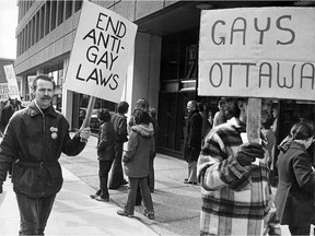 Members of Gays of Ottawa protest outside the Journal newspaper office on March 21, 1975 after police release the names of male clients of a "nude modeling agency" that the Journal had dubbed a "homosexual vice ring." After the names were published, Warren Zufelt, one of the named men, jumped to his death from his apartment window.