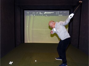 Laurent Hurtubise uses the same 6 iron in the Golf Town simulator in St-Hubert that he used on Jan. 16 to shoot a hole-in-one at a PGA pro-am event in California.
