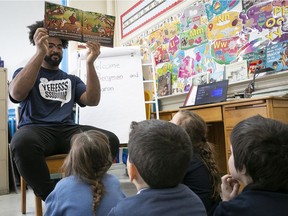 Alouettes defensive-tackle Woody Baron, reads his book to kids at Nesbitt school on Jan. 24, 2020.