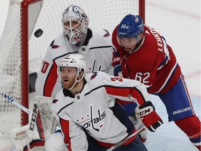 Washington Capitals' Nick Jensen (3) looks at flying puck with Montreal Canadiens' Artturi Lehkonen (62) in front of Washington Capitals' Braden Holtby, during first period NHL action in Montreal on Monday January 27, 2020.