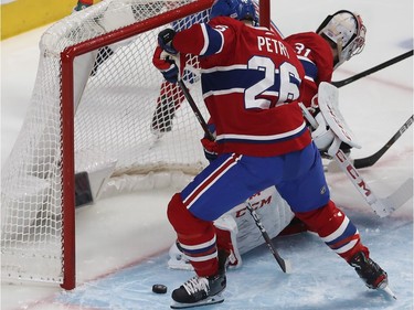 Montreal Canadiens' Jeff Petry (26) pushes the puck with his skate into the net of Montreal Canadiens goaltender Carey Price during the second period in Montreal on Monday January 27, 2020. The goal was attributed to Washington Capitals' Travis Boyd.