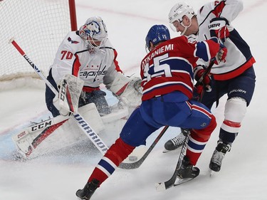 Montreal Canadiens' Jesperi Kotkaniemi (15) battles for puck with Washington Capitals' Travis Boyd (72) in front of goaltender Braden Holtby, during first period NHL action in Montreal on Monday January 27, 2020.