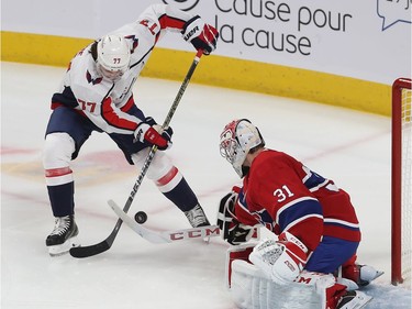 Washington Capitals' T.J. Oshie (77) tries to get shot on Montreal Canadiens goaltender Carey Price, during the first period in Montreal on Monday January 27, 2020.