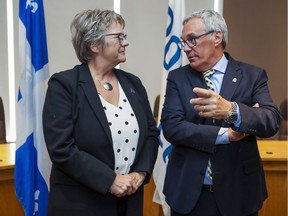 Pointe-Claire Mayor John Belvedere speaks with Chantal Rouleau, Minister responsible for the Metropolis and Montreal Region, following a press conference to announce infrastructure funding.