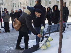 Pasha Khan, a professor in Islamic studies at McGill University in Montreal, lays a rose at the base of a tree at the school Wednesday, January 29, 2020 that was planted to commemorate the victims the terrorist shooting at a Quebec City mosque three years ago today. McGill held a ceremony this morning to remember the six men killed in the shooting.