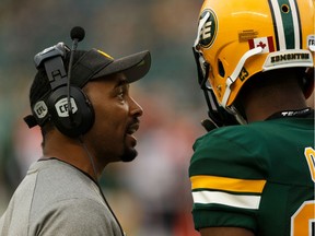 Barron Miles speaks with Eskimos' Godfrey Onyeka during a game versus last season. Miles is the Als' new defensive-backs coach and pass-game co-ordinator.