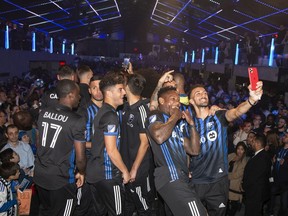 Impact players take selfies in front of their fans as the team is introduced at a Griffintown nightclub.