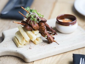 Anticucho beef skewers are served with yucca fries at Pikeos.