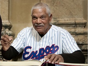 Felipe Alou signs the Golden Book as a group of former Montreal Expos visit city hall in Montreal on March 25, 2019.