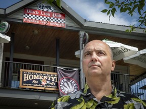 Bob Simotas, seen here outside his bakery and pub in Beaconsfield last June, recently closed his business. He had a dispute with the city over some store signs deemed illegal under municipal bylaws.