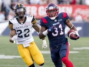 Montreal Alouettes William Stanback runs away from Hamilton Tiger-Cats Justin Tuggle for a long gain during Canadian Football League game in Montreal Thursday July 4, 2019.