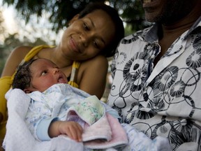 Naïs Acacia, with parents Nadège Bien-Aimé Acacia (left) and Aly Acacia, was born two days after the earthquake struck. Because Aly has a Canadian passport, the embassy took them in.