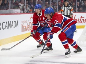 Montreal Canadiens' Brendan Gallagher, left, and Max Domi track the puck into the corner during the first period against the San Jose Sharks in Montreal on Oct. 24, 2019.