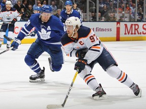 Oilers' Connor McDavid swings around Leafs' Morgan Rielly during a game on Monday. Expect the Bell Centre to be sold out Thursday when the NHL's best player visits.
