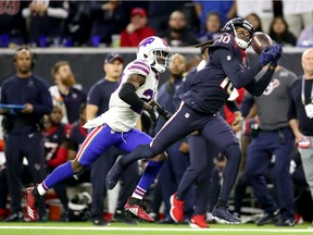 DeAndre Hopkins #10 of the Houston Texans catches a 41-yard pass against Tre'Davious White #27 of the Buffalo Bills during the fourth quarter of the AFC Wild Card Playoff game at NRG Stadium on January 04, 2020 in Houston, Texas.