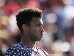 Felix Auger-Aliassime of Canada looks on during his Men's Singles first round match against Ernests Gulbis of Latvia on day two of the 2020 Australian Open at Melbourne Park on January 21, 2020 in Melbourne, Australia.