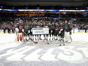 ST LOUIS, MISSOURI - JANUARY 25:  (L-R) David Rittich #33 of the Calgary Flames, Anze Kopitar #11 of the Los Angeles Kings, Max Pacioretty #67 of the Vegas Golden Knights, Tomas Hertl #48 of the San Jose Sharks, Connor McDavid #97 of the Edmonton Oilers, Leon Draisaitl #29 of the Edmonton Oilers, Elias Pettersson #40 of the Vancouver Canucks, Matthew Tkachuk #19 of the Calgary Flames, Quinn Hughes #43 of the Vancouver Canucks, Mark Giordano #5 of the Calgary Flames and Jacob Markstrom #25 of the Vancouver Canucks of the Pacific Division pose for a photo with the winner's check after the 2020 NHL All-Star Game between the Atlantic Division and Pacific Division at the Enterprise Center on January 25, 2020 in St Louis, Missouri.