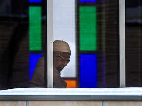 A member of the Baitul-Mukarram Mosque in Montreal keeps a close eye on the goings-on at street level below on Friday December 15, 2017. At the time, the mosque was one of two at the centre of false allegations reported on TVA. Now, the mosque is among several in Montreal holding open houses in connection with the 2020 edition of Muslim Awareness Week.